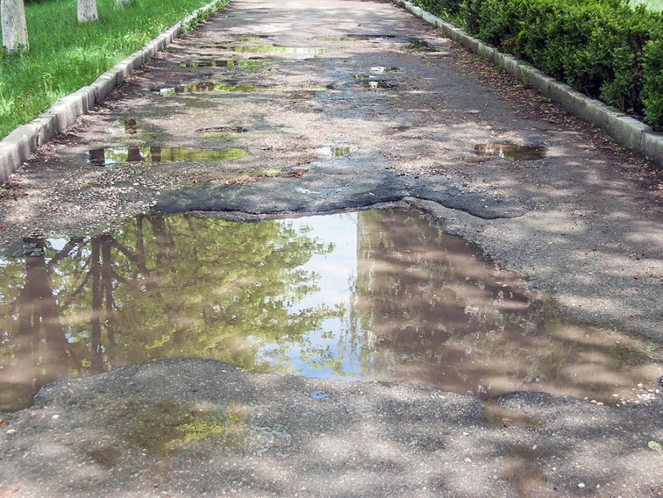 A water main leak under the driveway can create pooling water.
