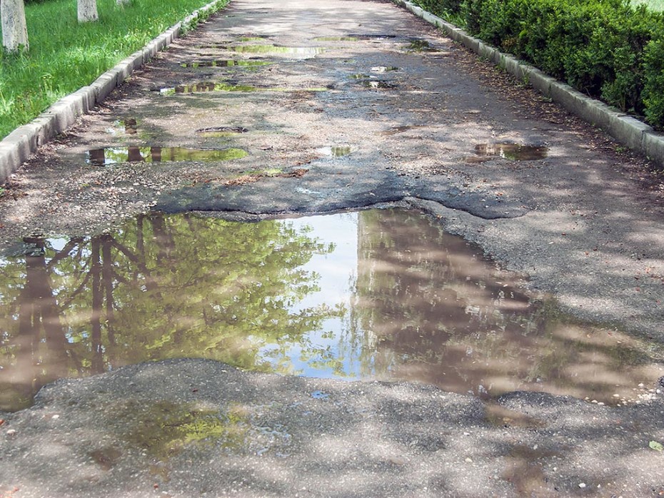 A water main leak under the driveway can create pooling water.