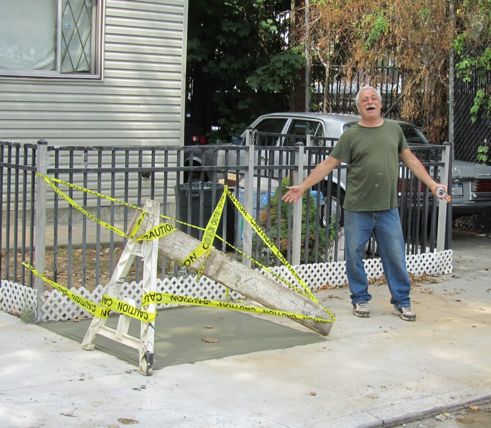 Happy customer standing next to recently finished water main repair.