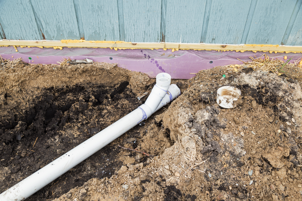 Backwater sewer valves installation - An exposed sewer line undergoing repairs.